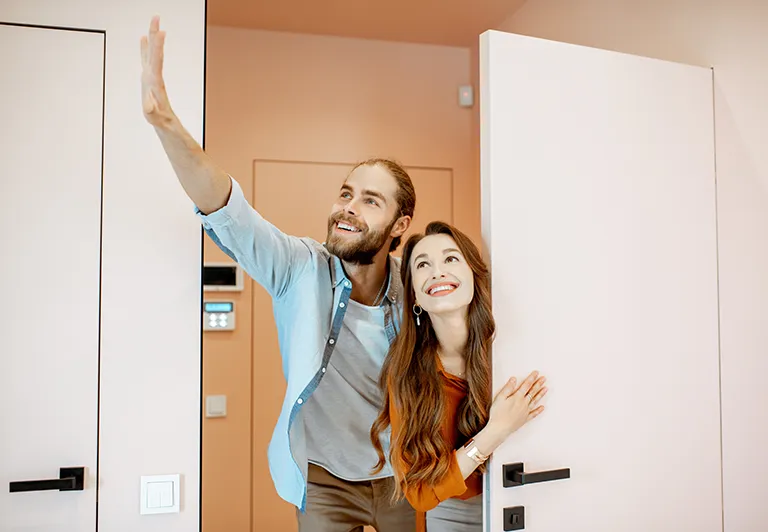 man and woman walking through open door