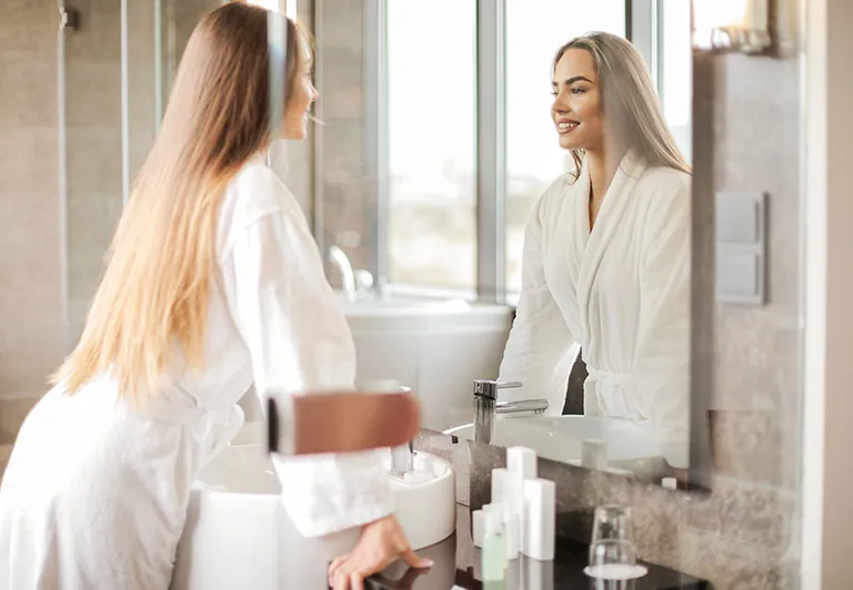 woman looking at herself in the mirror