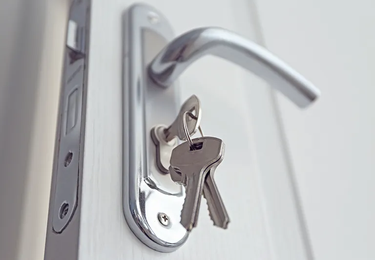 images of a door with a key in the lock